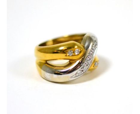 A diamond set ring, the cross-over design in yellow and white, set with round brilliant cut diamonds, finger size L The ring 