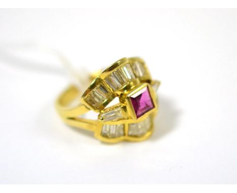 A ruby and diamond ring, a square step cut ruby in a yellow rubbed over setting, with a tapered baguette cut diamond to each 