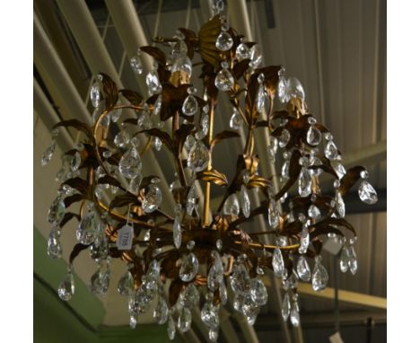 A reproduction gilded chandelier with cut glass drops