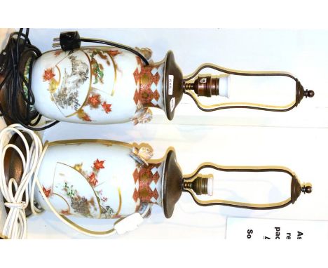 >A pair of Kutani porcelain baluster vases with butterfly handles, typically painted with asymmetric panels, 29cm high, mount