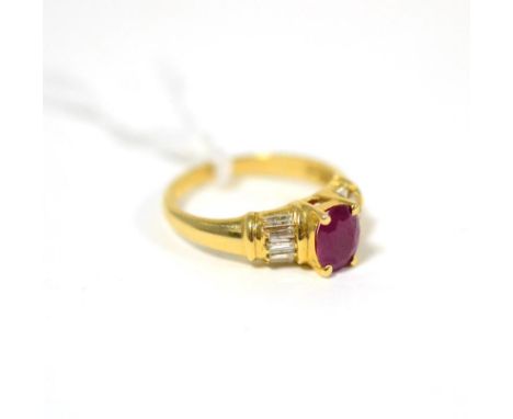 A ruby and diamond ring, an oval cut ruby in yellow claw setting, to baguette cut diamond set shoulders, on a yellow plain po