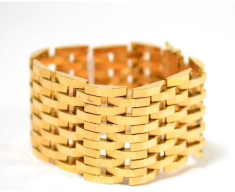 A broad gate bracelet, measures 19cm by 4.2cm Good condition. Tongue and box catch, and two figure-of-eight safety catches. S
