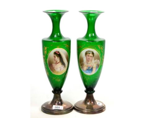 A pair of Victorian green glass vases, each painted with a relief oval portrait panel, with plated bases, 37cm high Both vase