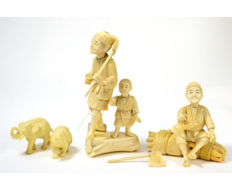 A Japanese ivory group of figures, Meiji period, including a wood cutter and a wine merchant, together with an ivorine elepha