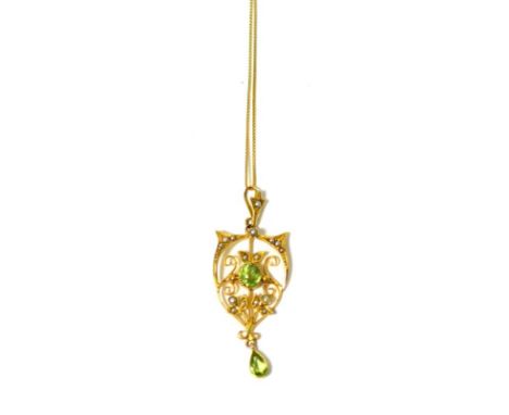 A peridot and seed pearl pendant on chain, an oval cut peridot in milled yellow setting, within a seed pearl set frame, suspe