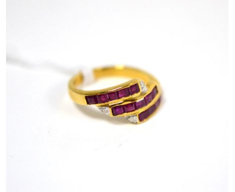 A ruby and diamond three row ring, set with calibré cut rubies in yellow channel settings, each row terminating with a round 