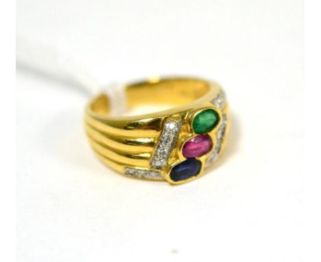 A multi-gemstone and diamond ring, an oval cut sapphire, ruby and emerald in yellow rubbed over settings, with pavé set brill