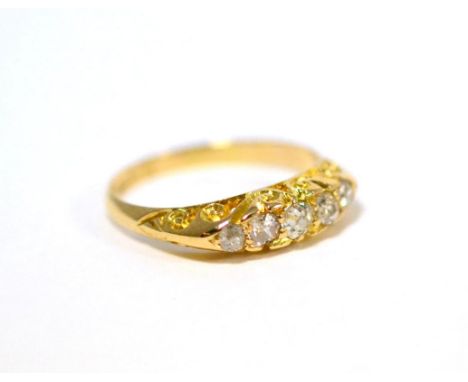 An 18ct gold diamond five stone ring, the graduated old cut diamonds in yellow claws, on a scroll setting, total estimated di