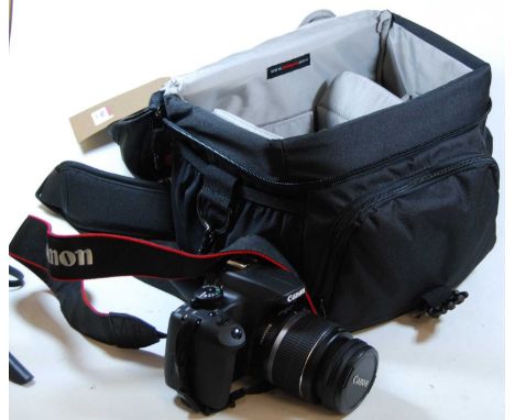 A Canon 1000D digital camera, with additional 70/300 lens, in case with accessories