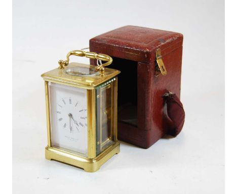 Howard James &amp; Co early 20th century lacquered brass cased carriage clock having signed white enamel dial, silvered visib