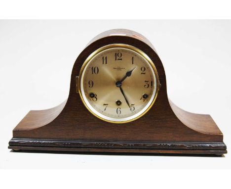 An early 20th century oak cased mantel clock, the silvered dial showing Arabic numerals and signed Bravingtons Ltd London, th