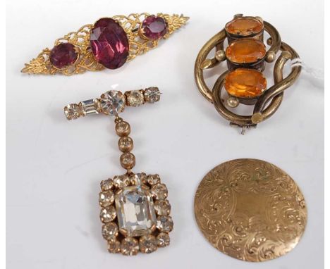 A gilt metal and amethyst set brooch; together with a pinchbeck and orange stone set brooch; a paste set pendant brooch etc 