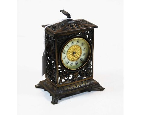 An early 20th century pierced brass cased mantel clock, by the British Union Clock Company, having enamelled chapter ring wit