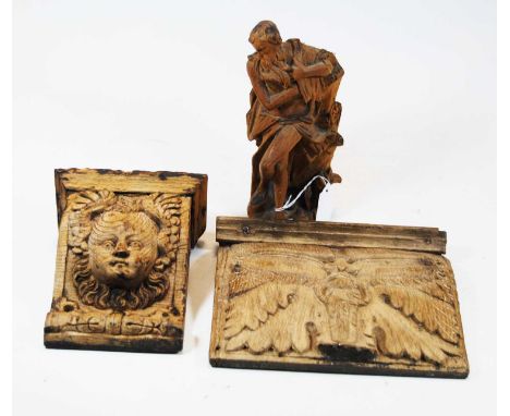 A 19th century carved oak bracket, decorated with a mask of a cherub , h.19cm; together with a carved softwood figure of a ma