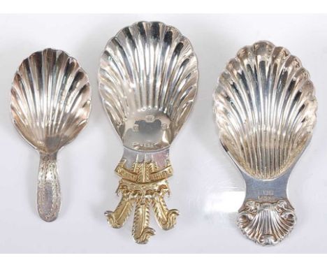 A modern Roberts &amp; Belk silver and silver gilt caddy spoon, with shell bowl and gilded fleur de lis; together with anothe