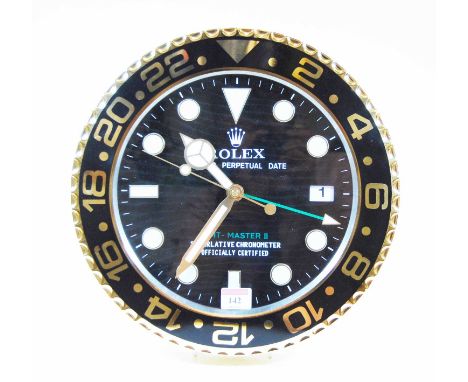 A contemporary wall clock, the dial in the form of a Rolex Perpetual Date GMT Master II watch dial, the quartz movement with 