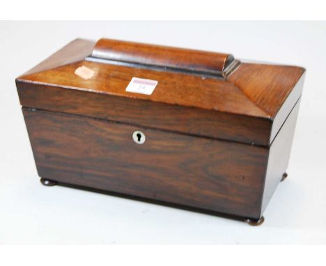 A Victorian rosewood tea caddy, of sarcophagus form, with mother of pearl escutcheon, standing on four disc feet, with associ