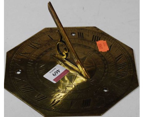 A brass sundial, the outer scale with Roman numerals, the inner scale with compass directions, dated 1649, 18cm