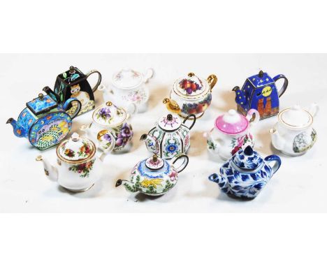 A collection of miniature teapots in china and enamelled metal to include Royal AlbertCondition report: Five enamel teapots a