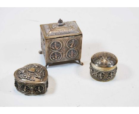 An early 20th century Eastern white metal tea caddy, of rectangular form, each side relief decorated with a deity, raised on 