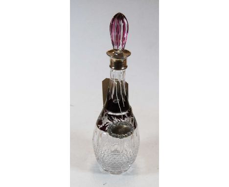 A ruby flash overlaid decanter and stopper having silver collar, height 38cm, together with a silver decanter collar annotate