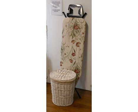 Ironing board and white wicker laundry hamper