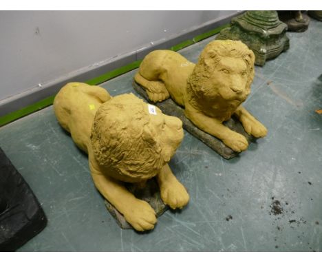 Pair of reproduction composite garden lion ornaments