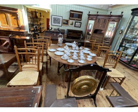 Jointed oak gate leg dining table and eight country style rush seated dining chairs including pair carvers (table 76cm by 153