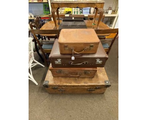 Large vintage leather trunk and three vintage suitcases.