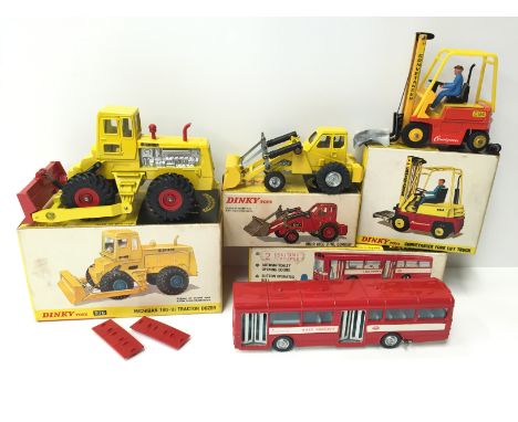 Four Dinky Toys models: 976 Michigan 180-III Tractor Dozer; 404 Conveyancer Fork Lift Truck; 437 Muir Hill 2-WL Loader; 283 S