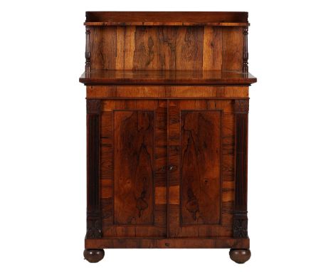 A REGENCY ROSEWOOD CHIFFONIER, CIRCA 1820. having a raised back with a gallery and turned supports above a pair of cupboard d