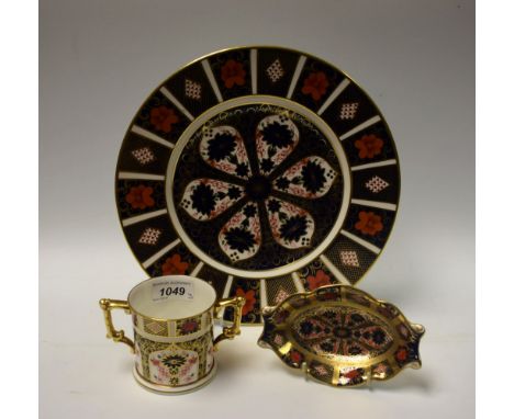 A Royal Crown Derby Imari palette 1128 pattern dinner plate, an 1128 pattern two handled loving cup, a shaped oval trinket di