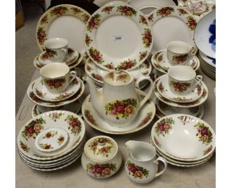 A Royal China English Rose dinner and tea service for eight including dinner plates, side plates, bowls, teapot, cups and sau