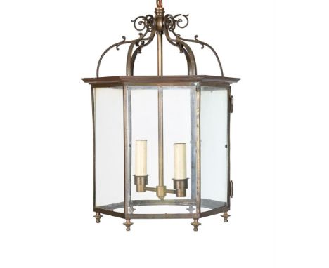 A BRASS HEXAGONAL 'GEORGIAN' LANTERN LATE 20TH CENTURY, BY ROBERT KIME LTD With a glazed door 57cm high, 39cm wideSupplied by