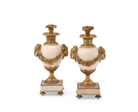 A PAIR OF FRENCH GILT BRONZE MOUNTED ALABASTER AND MARBLE URNS  LATE 19TH CENTURY IN THE LOUIS XVI MANNER  Ram head and swag 