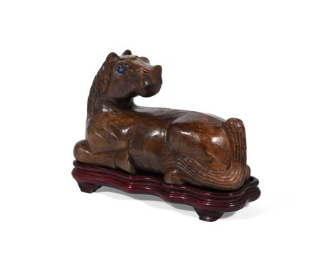 A LARGE CHINESE BROWN JADE BOULDER CARVING OF A HORSE  20TH CENTURY Recumbent with head turned back and blue hardstone inlaid