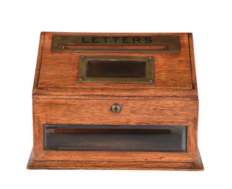 AN EDWARDIAN OAK AND BRASS MOUNTED LETTER BOX BY J.C. VICKERY, CIRCA 1905 With a maker's plaque for 'J.C. VICKERY, TO HIS MAJ