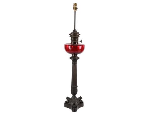 A BRONZE AND CRANBERRY GLASS TABLE OIL LAMP  FITTED FOR ELECTRICITY, LATE 19TH CENTURY AND LATER  92cm high  Condition Report