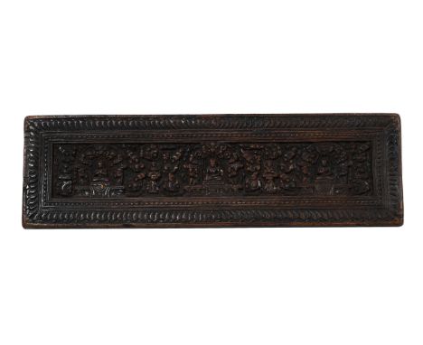 A TIBETAN CARVED WOOD SUTRA COVER  IN 14TH CENTURY STYLE Depicting seated Buddhist figures approximately 18cm high, 59cm wide