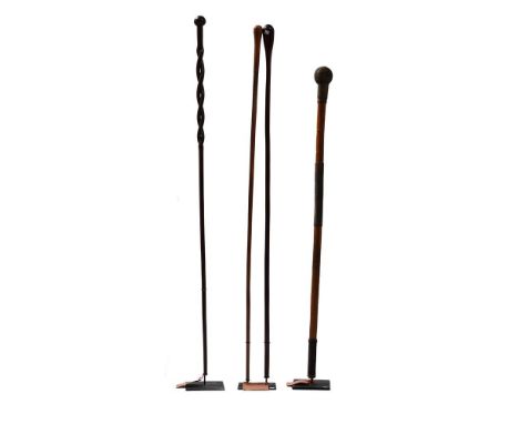 FOUR CARVED WOODEN WALKING STICKS ZULU, CONTEMPORARY All with metal display stands stick length ranging between 81 and 94cm  