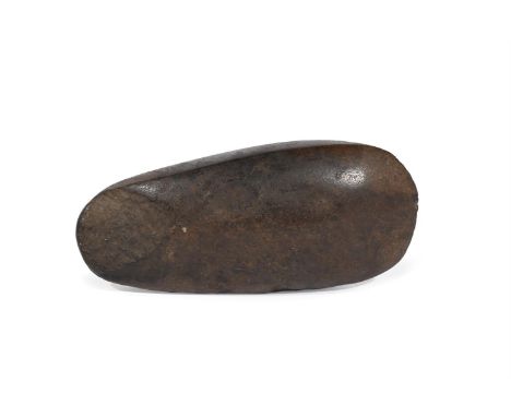 A STONE AXE HEAD BLADE  POSSIBLY AUSTRALASIAN  approximately 6cm high, 13cm wide, 3cm deep  Provenance: Private Collection