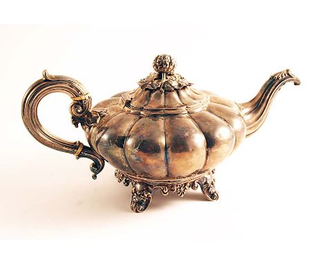 A WILLIAM IV TEA POT of melon-fluted form with a C-scroll handle and a fruit finial, by Messrs. Barnard, London 1836;  6"  (1