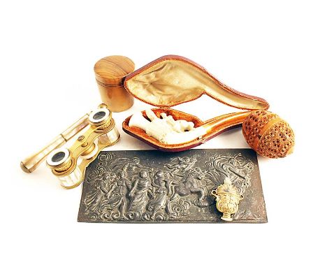 AN EMBOSSED LEAD PLAQUE  after the antique, a pair of mother of pearl and brass opera glasses, a meerschaum pipe carved with 