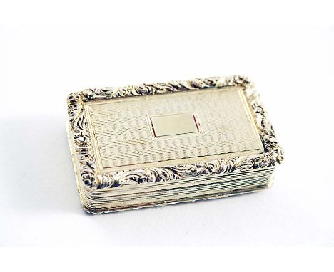 A GEORGE IV SILVERGILT RECTANGULAR VINAIGRETTE with engine-turned decoration, reeded sides and raised foliate borders, the co