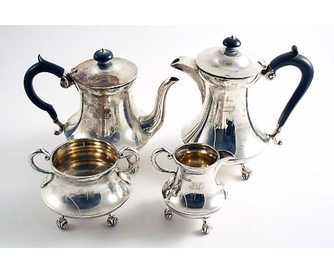 AN EDWARDIAN THREE-PIECE COFFEE SET with waisted circular bodies, scroll handles and scroll feet, each piece initialled & ins