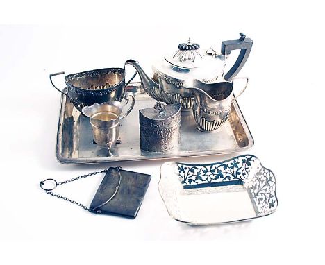 A MIXED LOT:- An engine-turned dressing table tray, Birmingham 1911, a three-piece tea set, Birmingham 1910, a small Dutch te