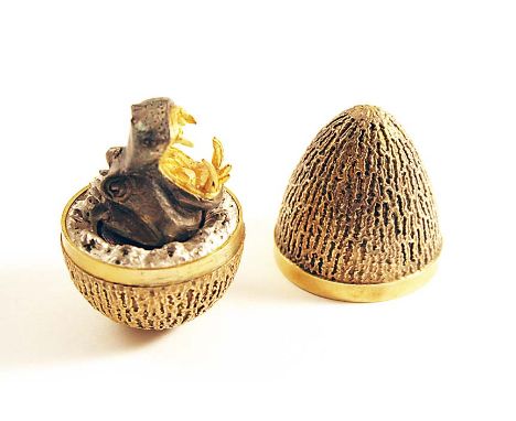 A LATE 20TH CENTURY SILVERGILT LIMITED EDITION SURPRISE EGG with a textured surface, the parcelgilt interior with the oxidise
