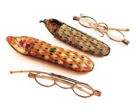 A PAIR OF GEORGE III SPECTACLES with hinged and extending side arms, no apparent maker's mark, London 1817, and another pair 