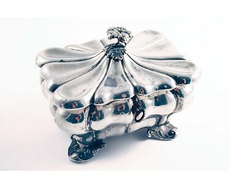 A MID 19TH CENTURY CONTINENTAL TEA CADDY of rounded rectangular form with lobed and fluted decoration, scroll feet and a flow