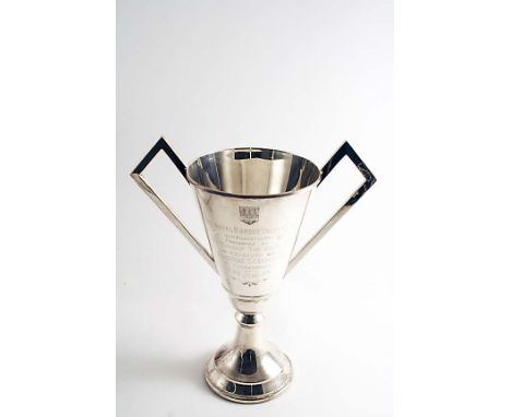 AN ART DECO TROPHY CUP with two angular handles, inscribed "The Royal Dorset Yacht Club 16th August 1935....to commemorate H.